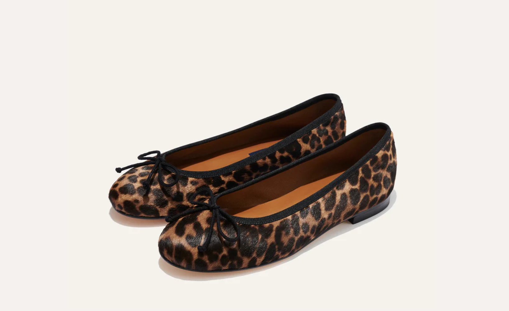 The Demi - Chocolate Leopard Haircalf by margaux-development: handmade in Spain, these ballet flats feature leopard print haircalf with black trim and small black bows, displayed on a plain light background.