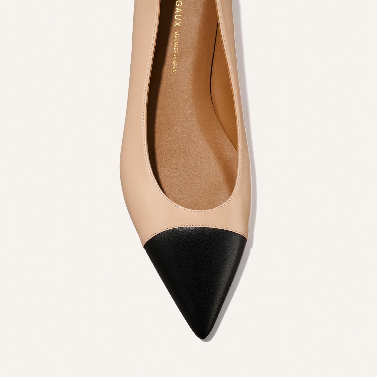The Alba - Dune and Black Nappa by Margaux: a beige ballet flat with a pointed toe and contrasting black cap, shown from above on a white background. Features a padded insole for comfort.