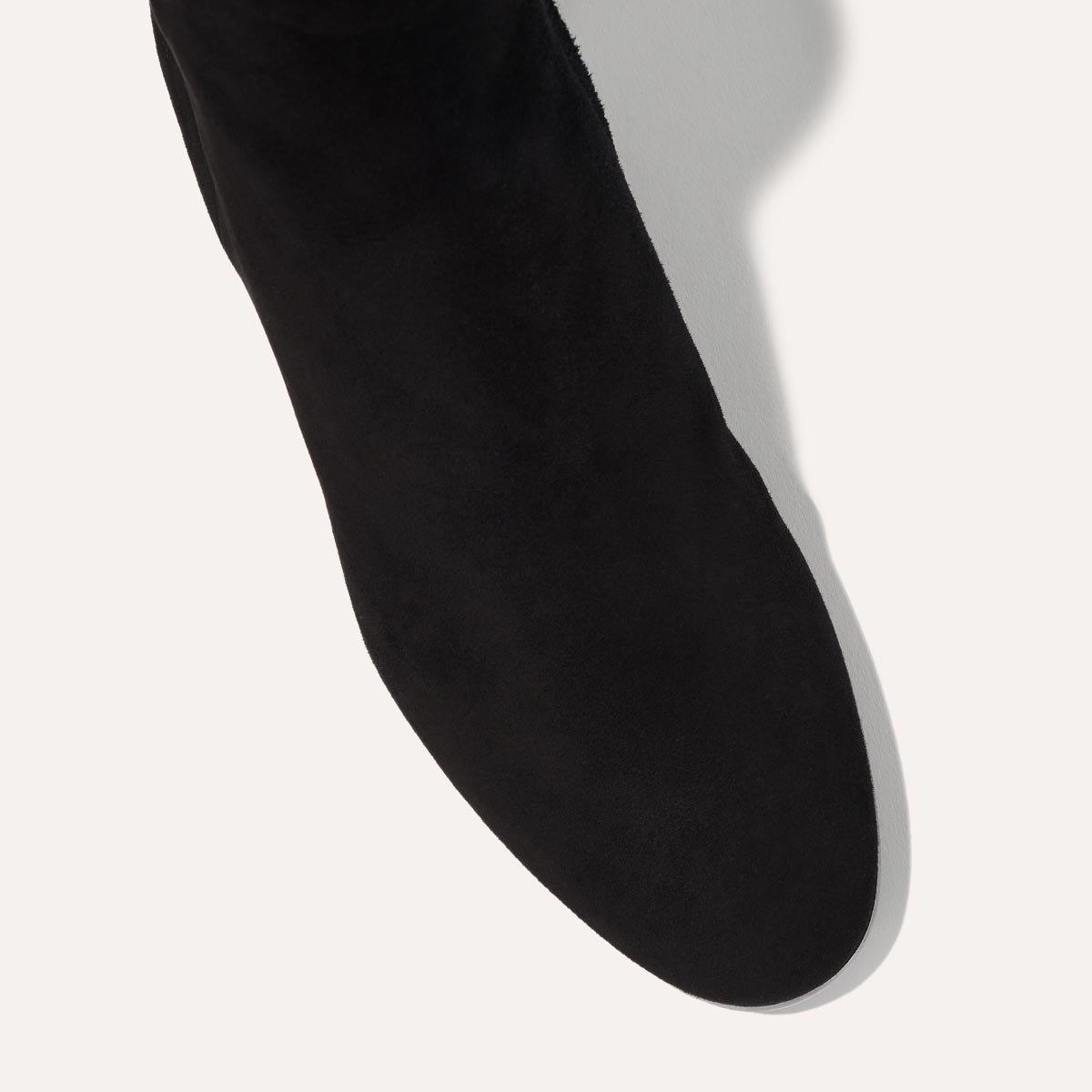 The Boot in Black Suede, featuring an elegant almond toe and block heel, crafted from high-quality Italian leather for a timeless and modern look.