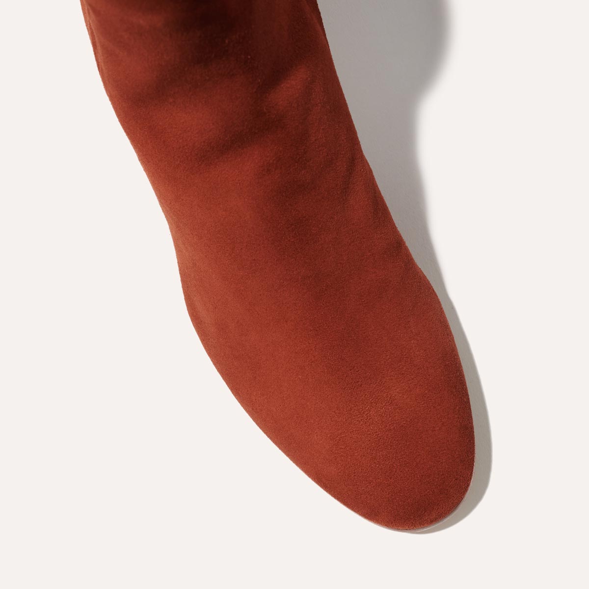 The Boot in Brandy Suede, featuring an elegant almond toe and block heel, crafted from high-quality Italian leather for a timeless and modern look.