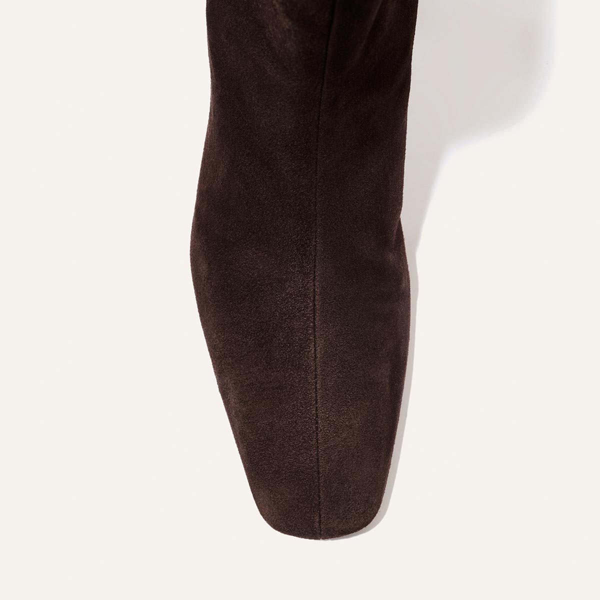 Top view of Margaux’s The Brera Boot in Molasses Suede, featuring a pointed toe, displayed on a plain white background.