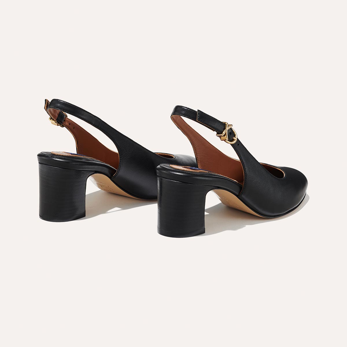 The Cluny Slingback in Black Nappa, featuring a sleek Italian nappa leather upper with an adjustable buckle and a comfortable 2.5-inch black heel.