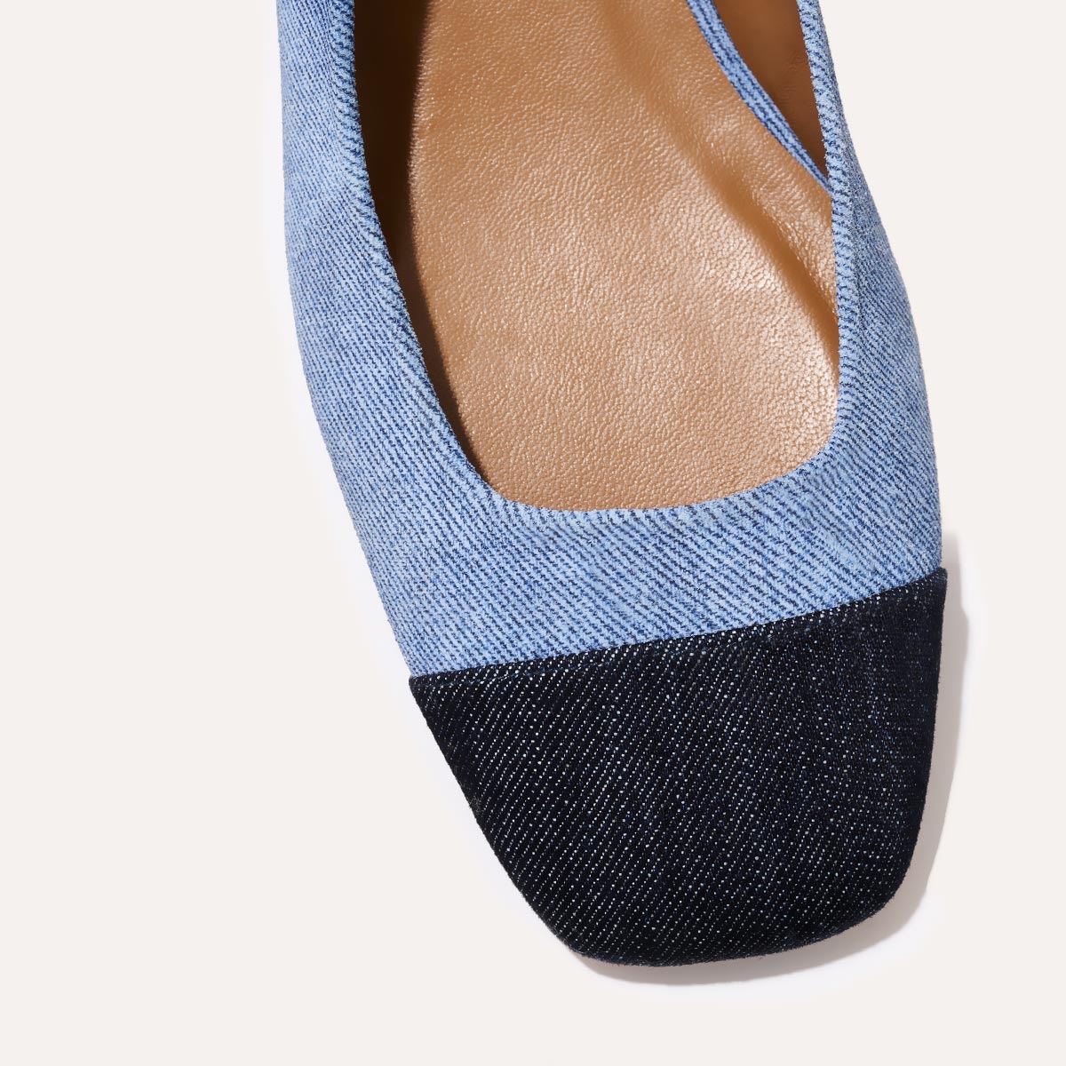A cap toe low heel slingback with denim
