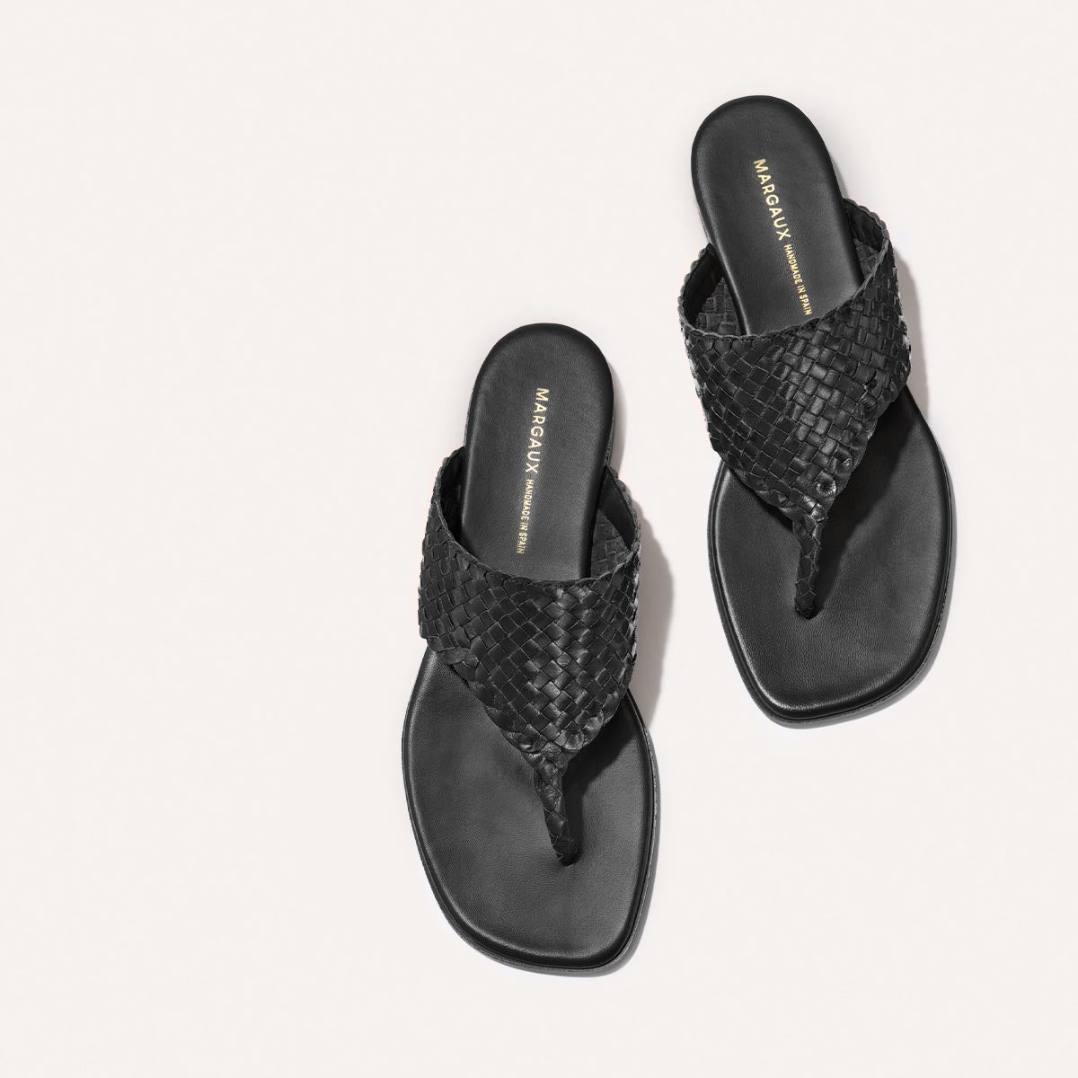 Black woven leather thong sandals