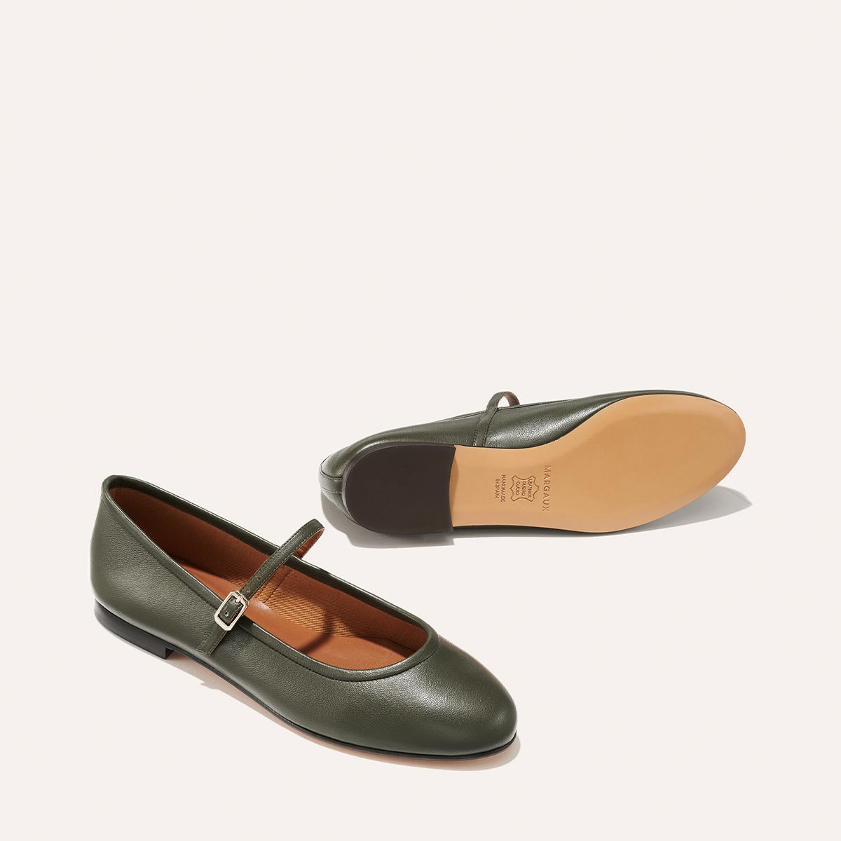 The Demi Jane in olive green nappa, a ballet flat with a rounded toe and an adjustable strap for a secure fit.