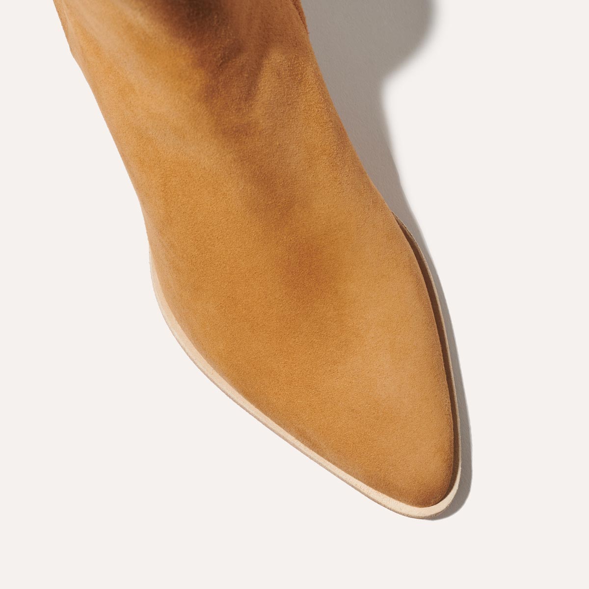 The Downtown Boot in Sahara Suede, a chic ankle-height design complete with a Western-inspired welt and a comfortable 2.5-inch stacked heel.