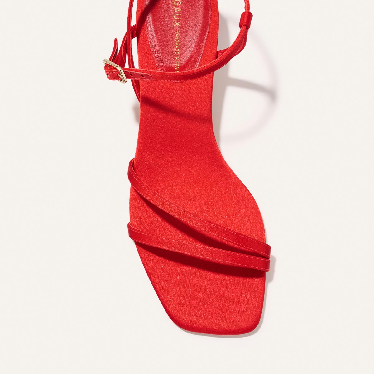 Top-down view of Margaux's The Dylan Sandal in Poppy Satin, featuring a square toe, thin straps over the toes and ankle, and a small gold buckle on the ankle strap, set against a light background.