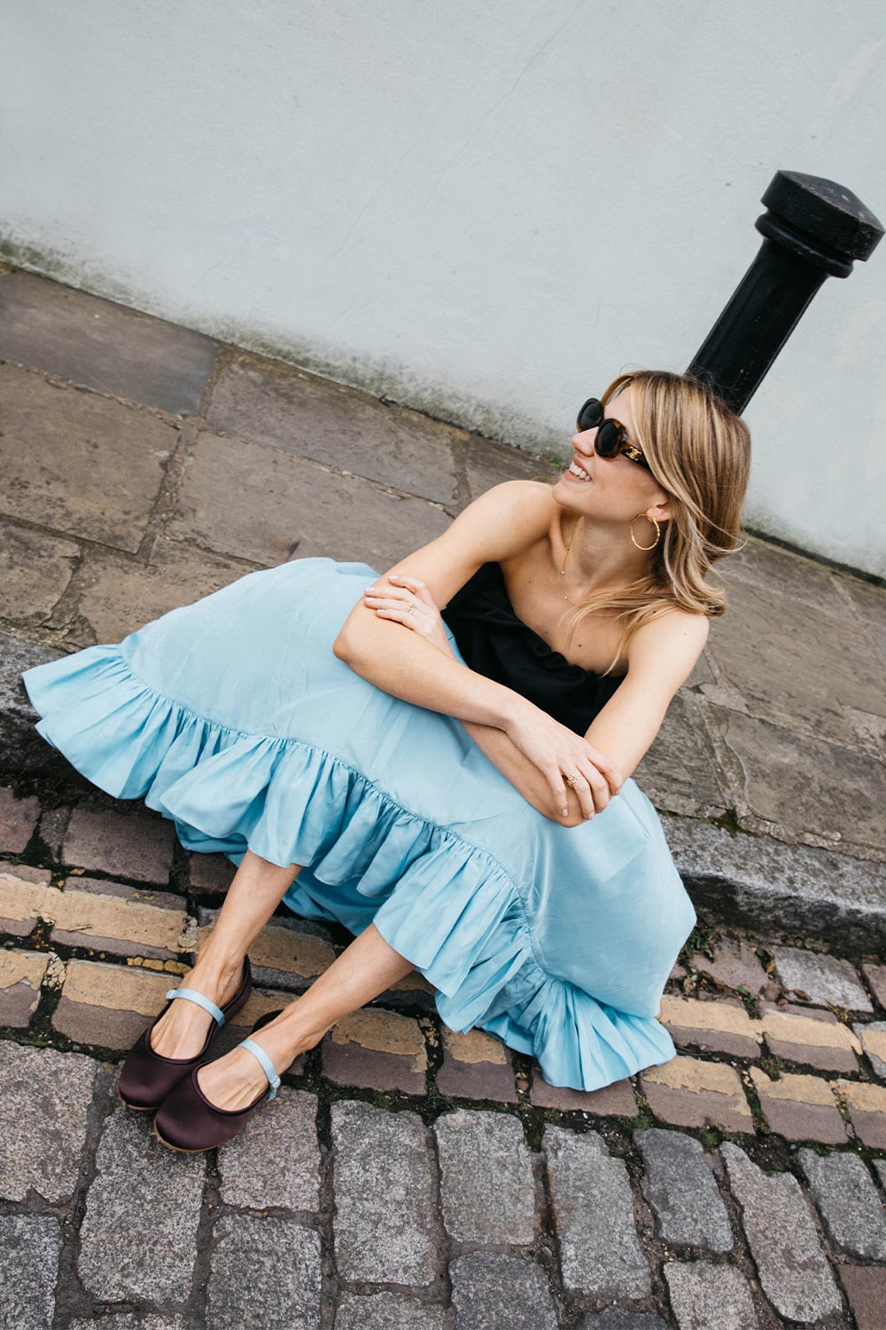 Matilda Goad wearing The Demi Jane in Chocolate Satin featuring a light blue adjustable strap