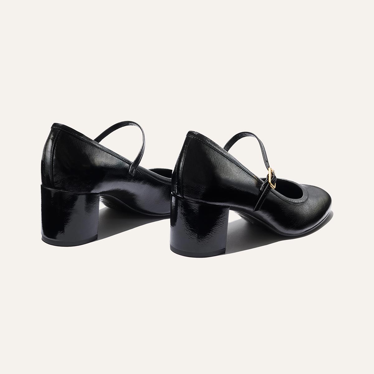 The Mira Jane - Black Crinkle Patent by margaux-development features shiny black crinkle gloss patent, block heels, and thin instep straps. Displayed on a plain light background.