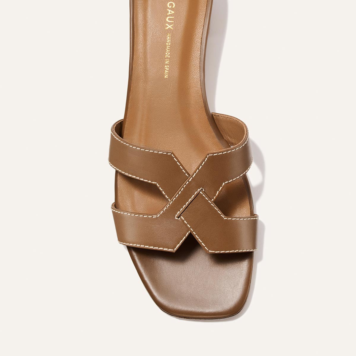The MX 35 - Mocha Calf by Margaux is a brown leather sandal with white stitching, wide crisscross straps, a square toe, and a comfortable block heel for easy walking.