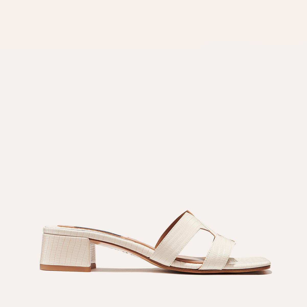 The MX 35 in Ecru Lizard, a slip-on sandal with structured straps, a subtly square toe and a comfortable 1.5-inch block heel.