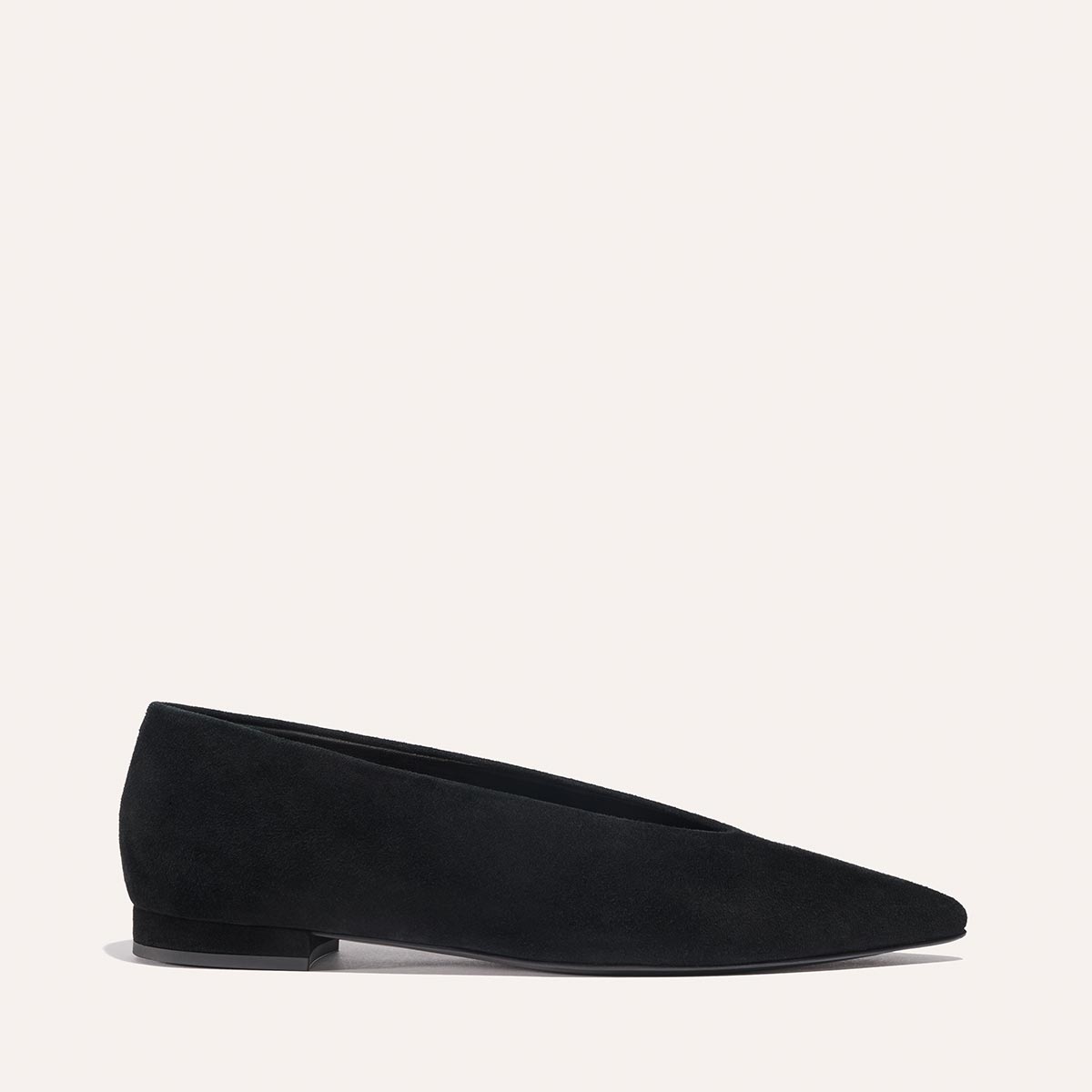 The Parra - Black Suede by margaux-development is a black suede pointed-toe flat with a structured silhouette, low heel, and high vamp, displayed in profile against a plain light background.