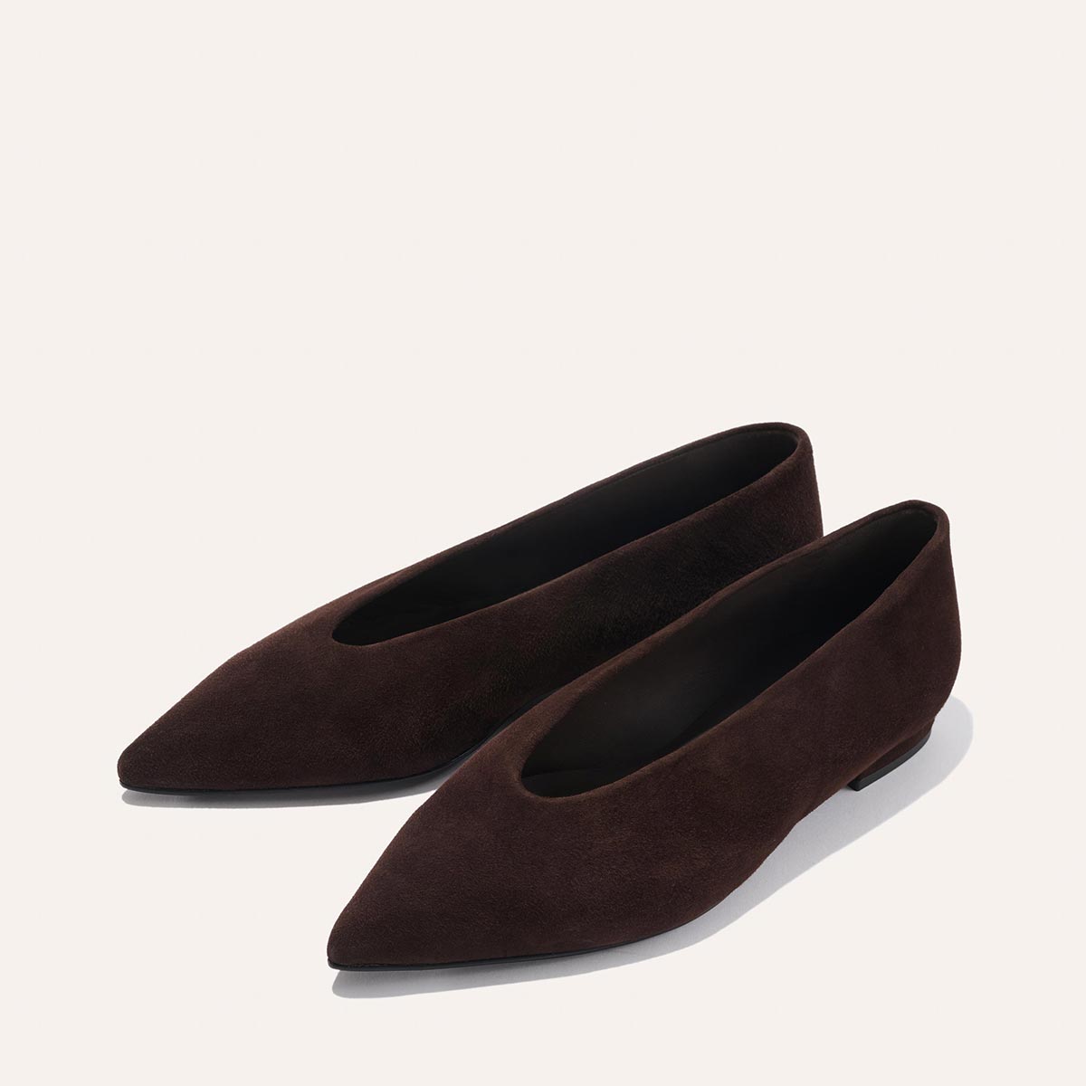 The Parra - Espresso Suede flats by margaux-development feature dark brown suede, a pointed toe, and low heels, shown against a plain light background.