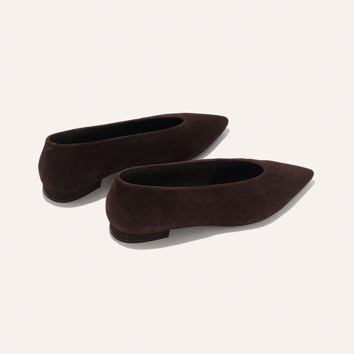The Parra - Espresso Suede by margaux-development: dark brown suede pointed-toe flats with low heels, shown on a neutral background.