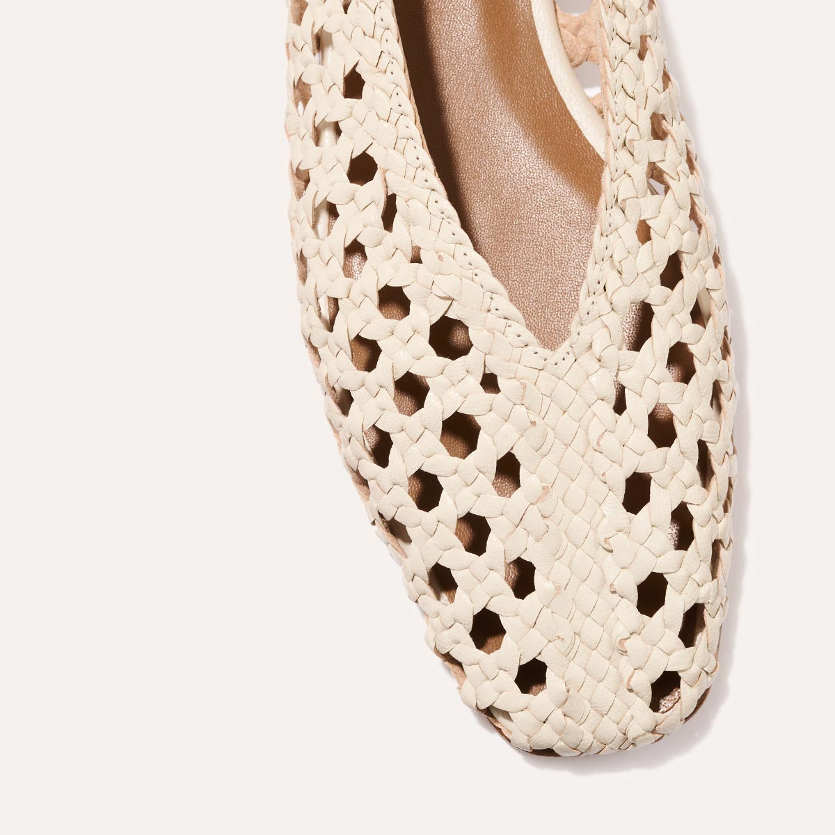 Close-up of The Woven Paz SS25 - Ecru Leather by Margaux, featuring a pointed toe and intricate handwoven cut-out pattern, photographed against a plain white background.