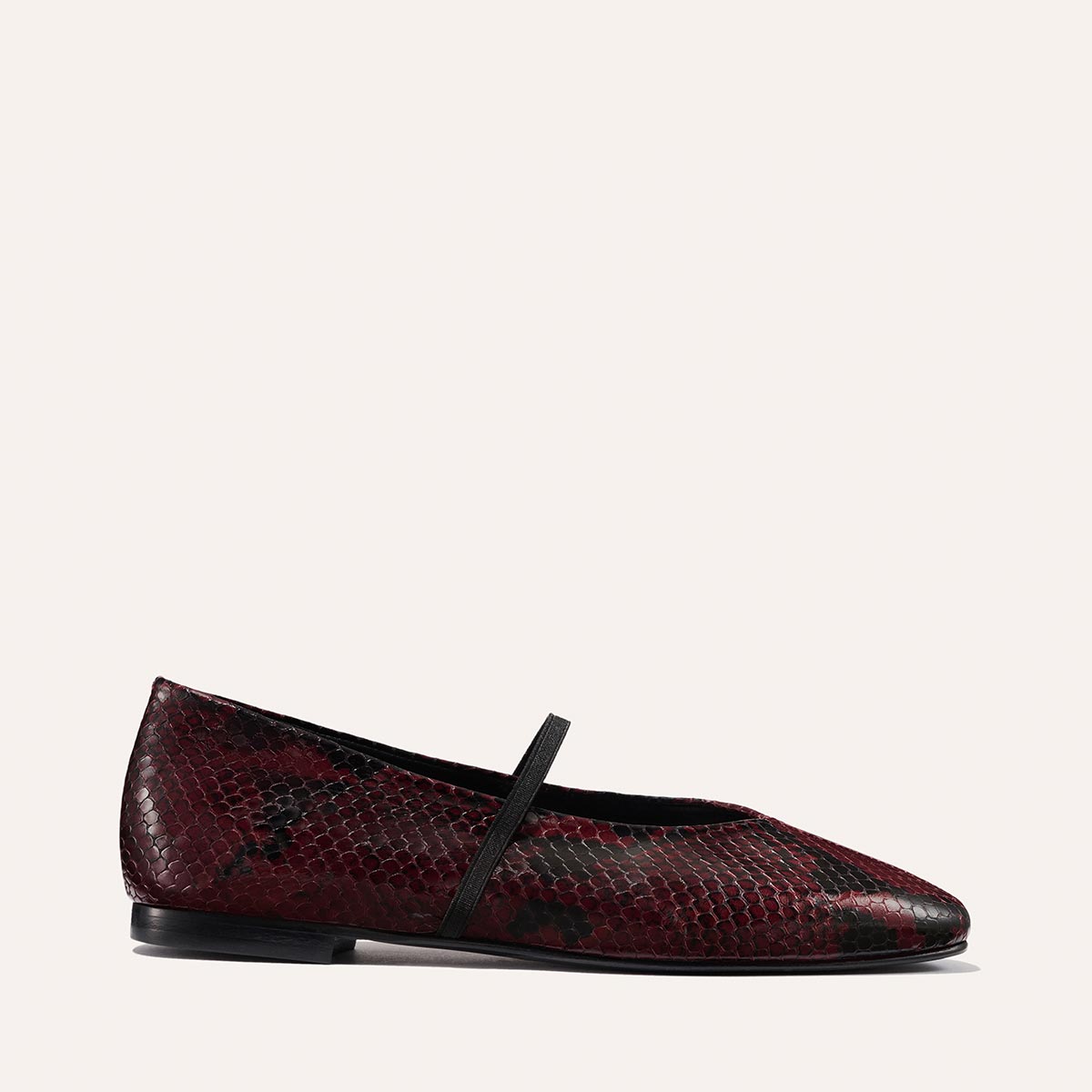 The Phoebe - Burgundy Python Embossed by margaux-development is a maroon and black deconstructed flat featuring a snakeskin pattern and a thin black instep strap, displayed in profile against a plain light background.