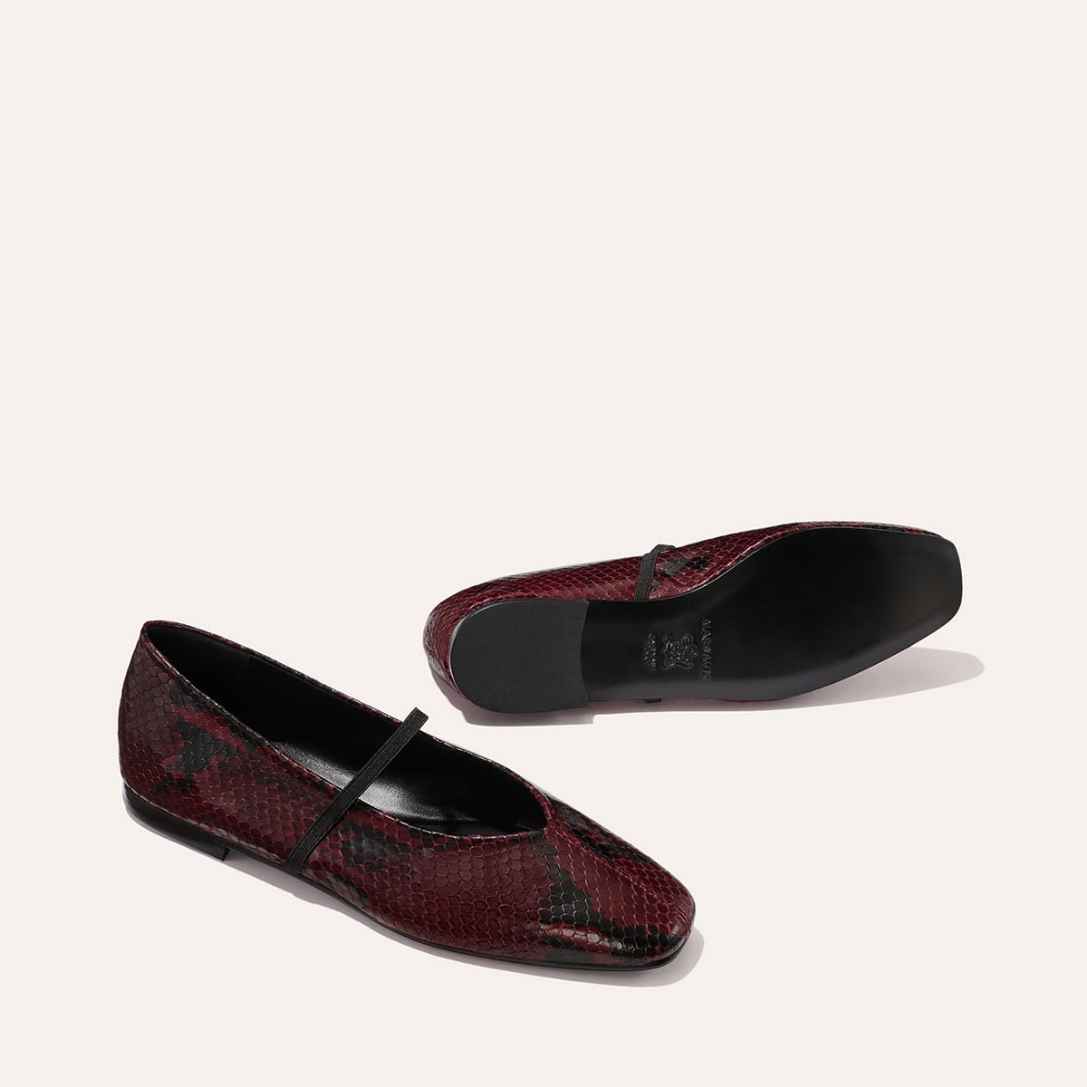 The Phoebe - Burgundy Python Embossed by margaux-development: ballet flats in burgundy python embossing with black soles and a slim black strap, crafted with sacchetto construction for exceptional softness, shown on a plain light background.