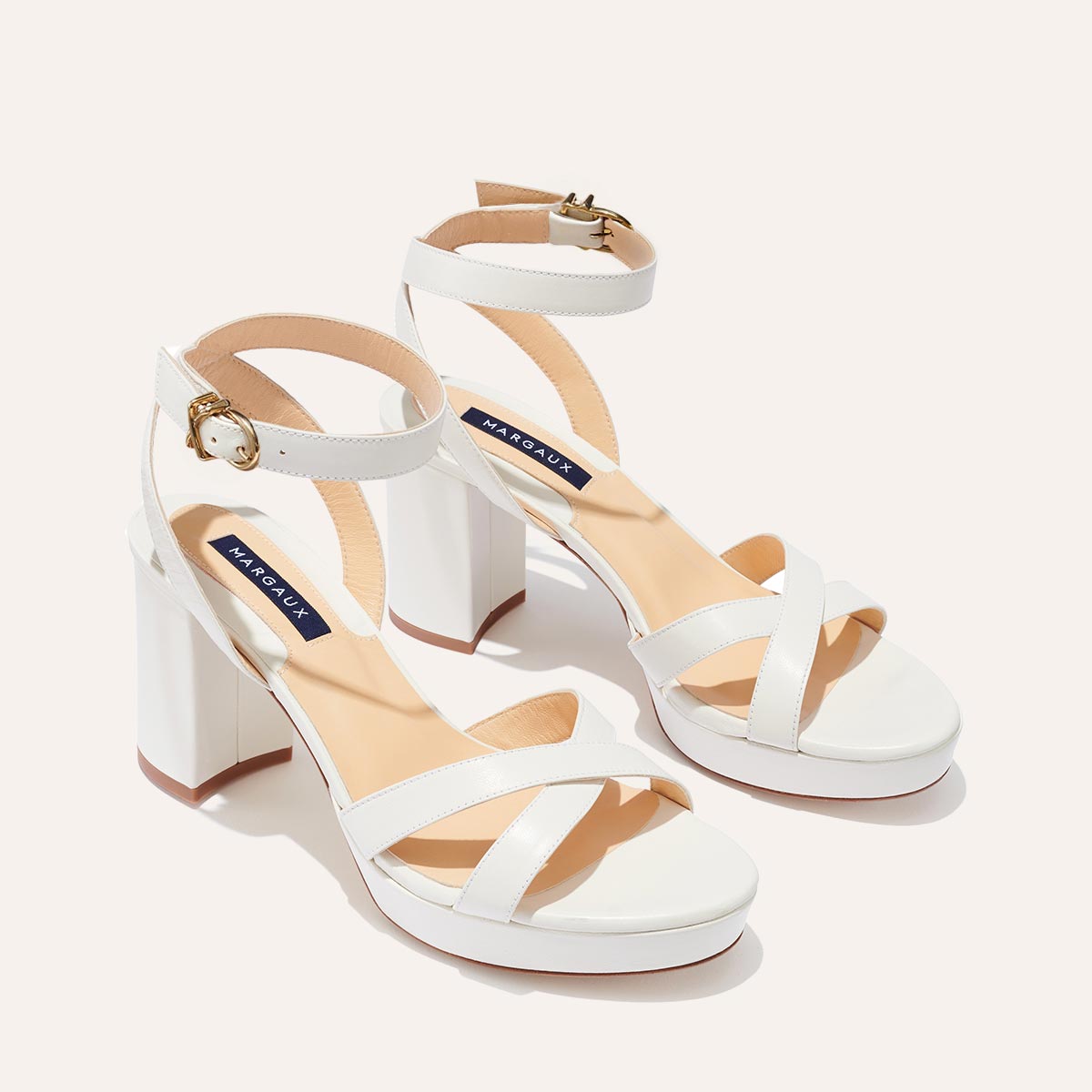 The Platform Sandal in Ivory Nappa, featuring a sleek ankle strap, perfectly placed straps across the toes and a comfortable 3.5-inch block heel.