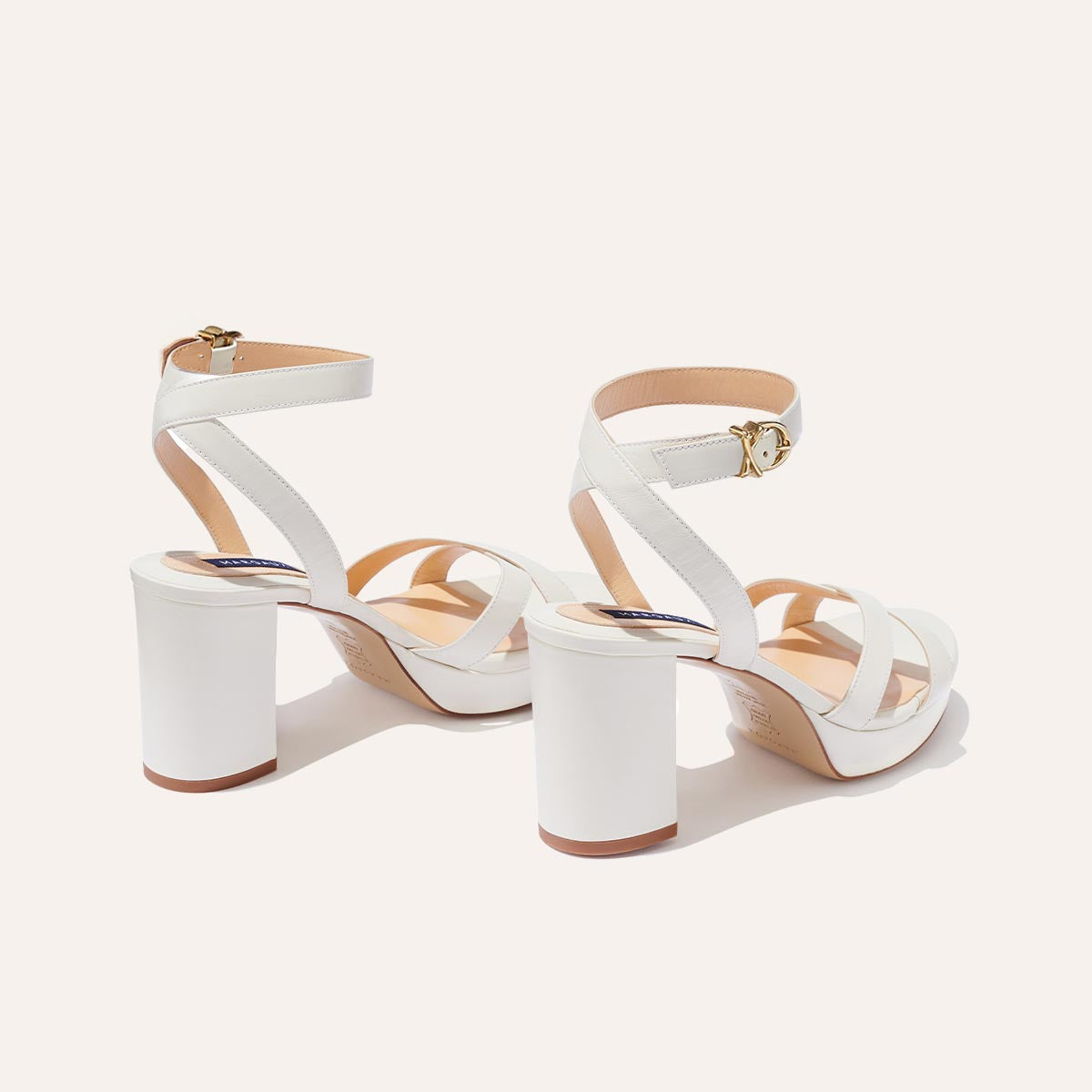 The Platform Sandal in Ivory Nappa, featuring a sleek ankle strap, perfectly placed straps across the toes and a comfortable 3.5-inch block heel.