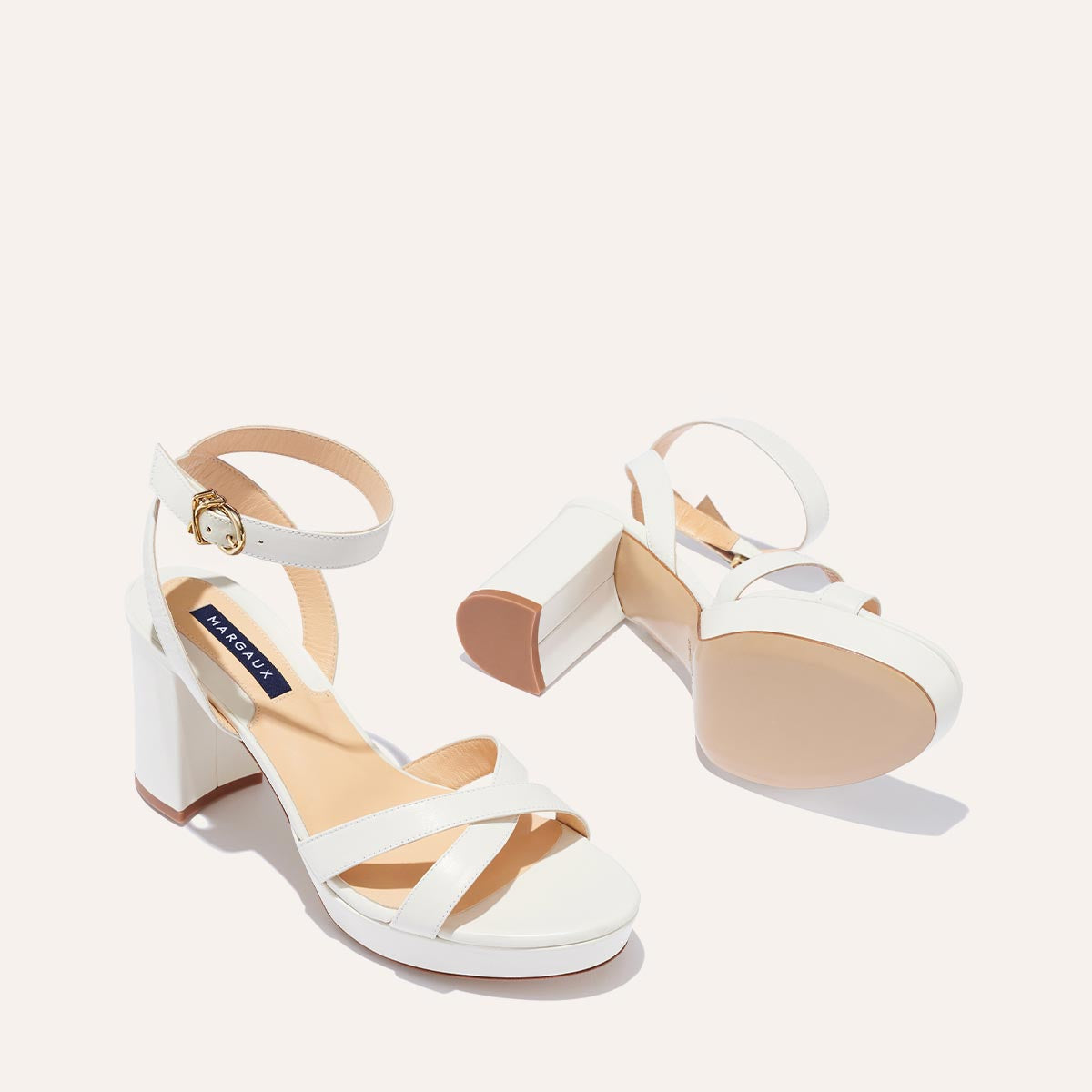 The Platform Sandal in Ivory Nappa, featuring a sleek ankle strap, perfectly placed straps across the toes and a comfortable 3.5-inch block heel.