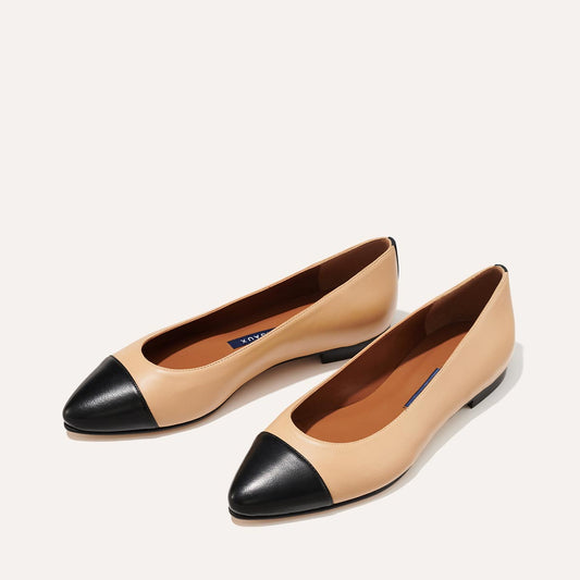 Margaux's classic and comfortable pointed-toe ballet flat, made in a soft, dune Italian nappa leather and black captoe