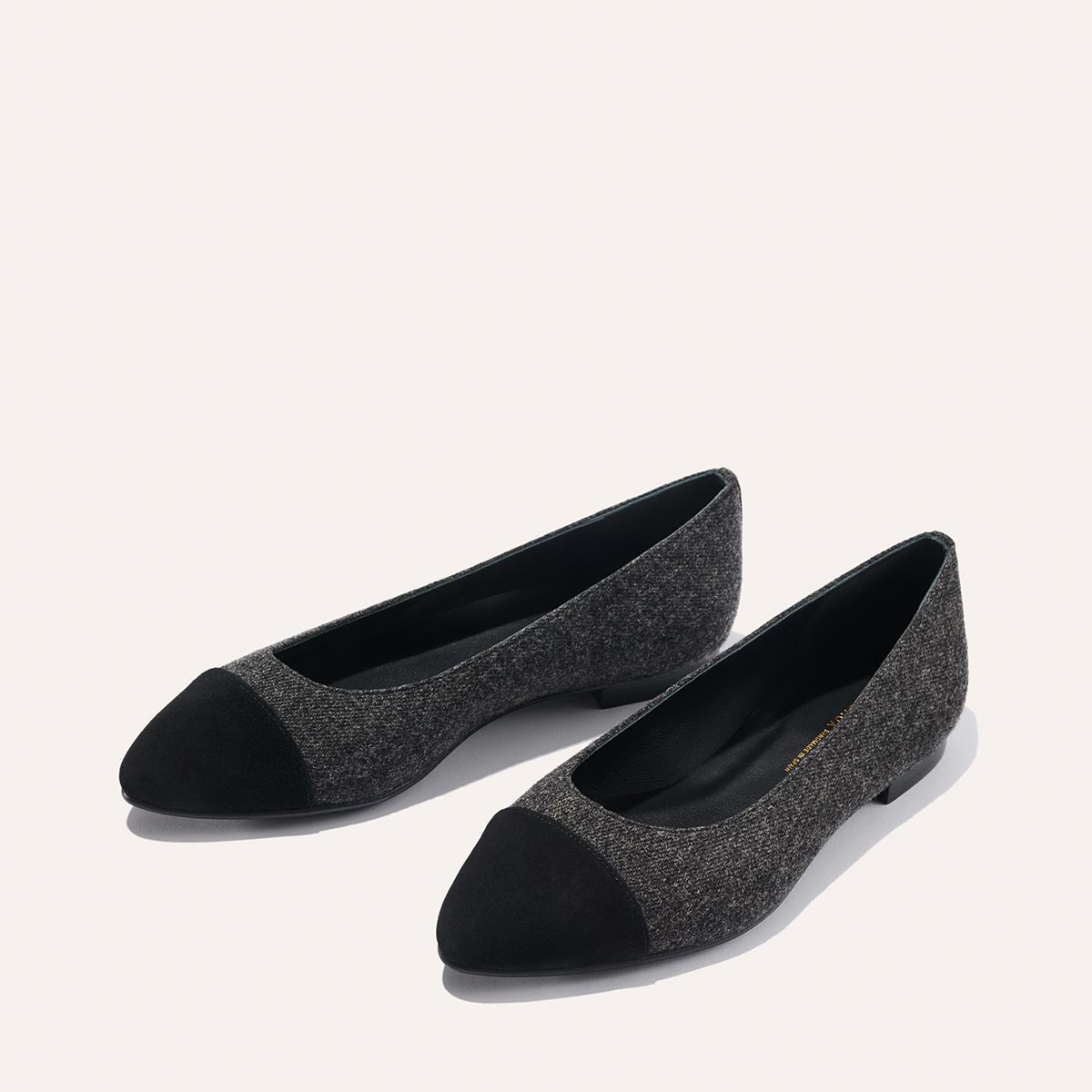The Pointe - Grey Flannel by margaux-development: Women's flats in dark gray textured fabric with black suede-like toe caps, featuring a sleek silhouette, shown on a light background.