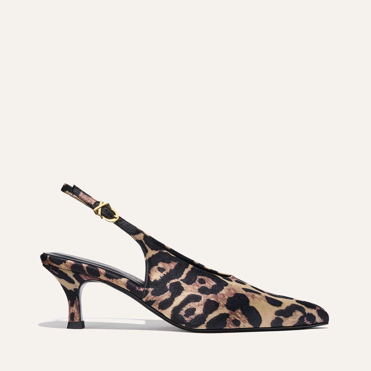 The Prado Sling - Leopard Satin by margaux-development is a women’s slingback heel with a pointed toe, low heel, leopard satin pattern, and an adjustable strap with a gold buckle.