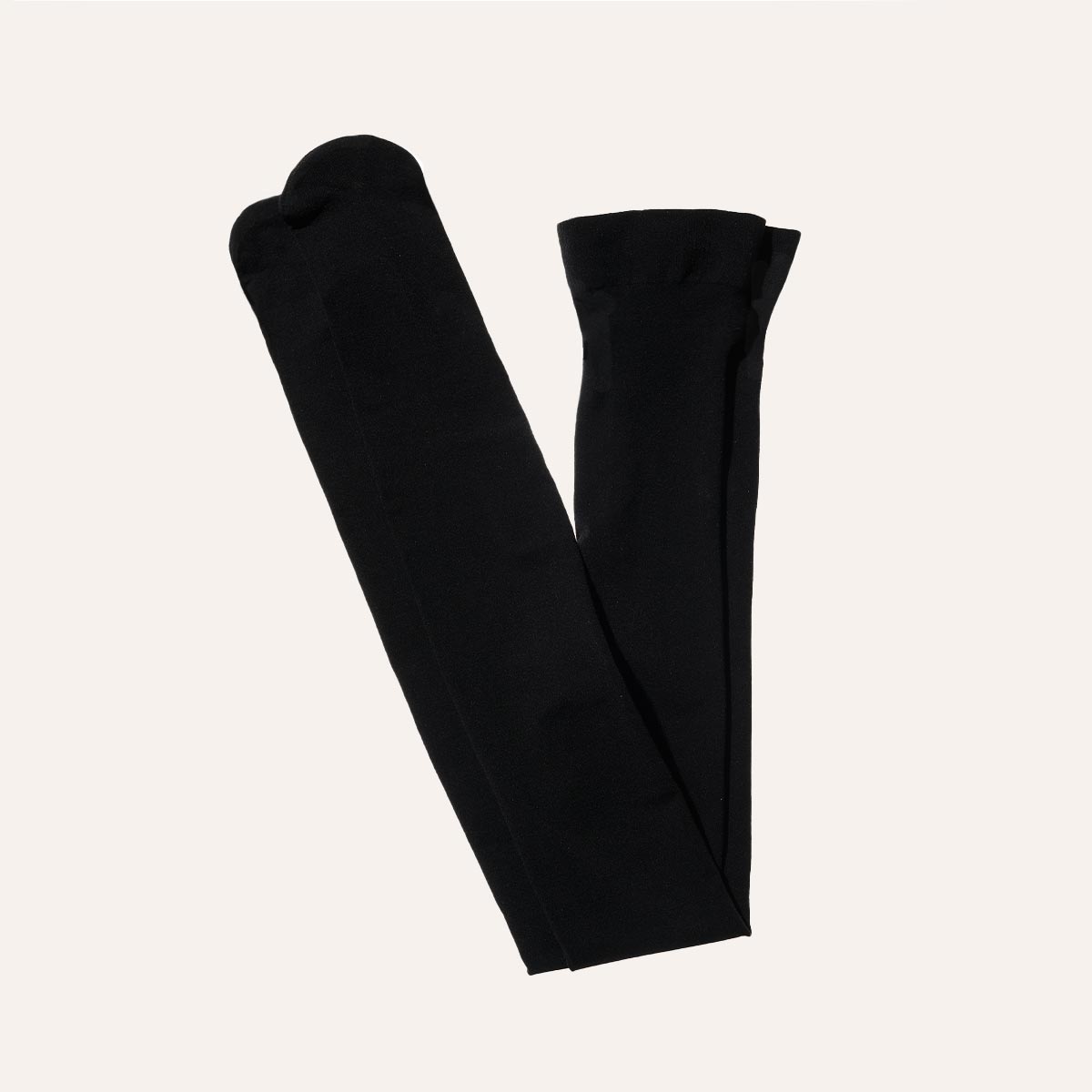 Margaux Semi-Sheer Tights in Black, neatly folded with toes and waistband visible, displayed against a plain off-white background.