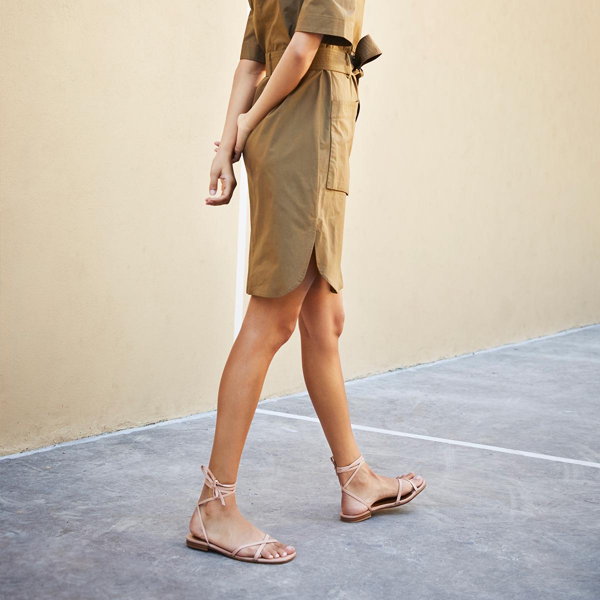 The Wrap Sandal in Rose Nappa, a minimal sandal featuring delicate ankle wraps and a subtly squared toe.