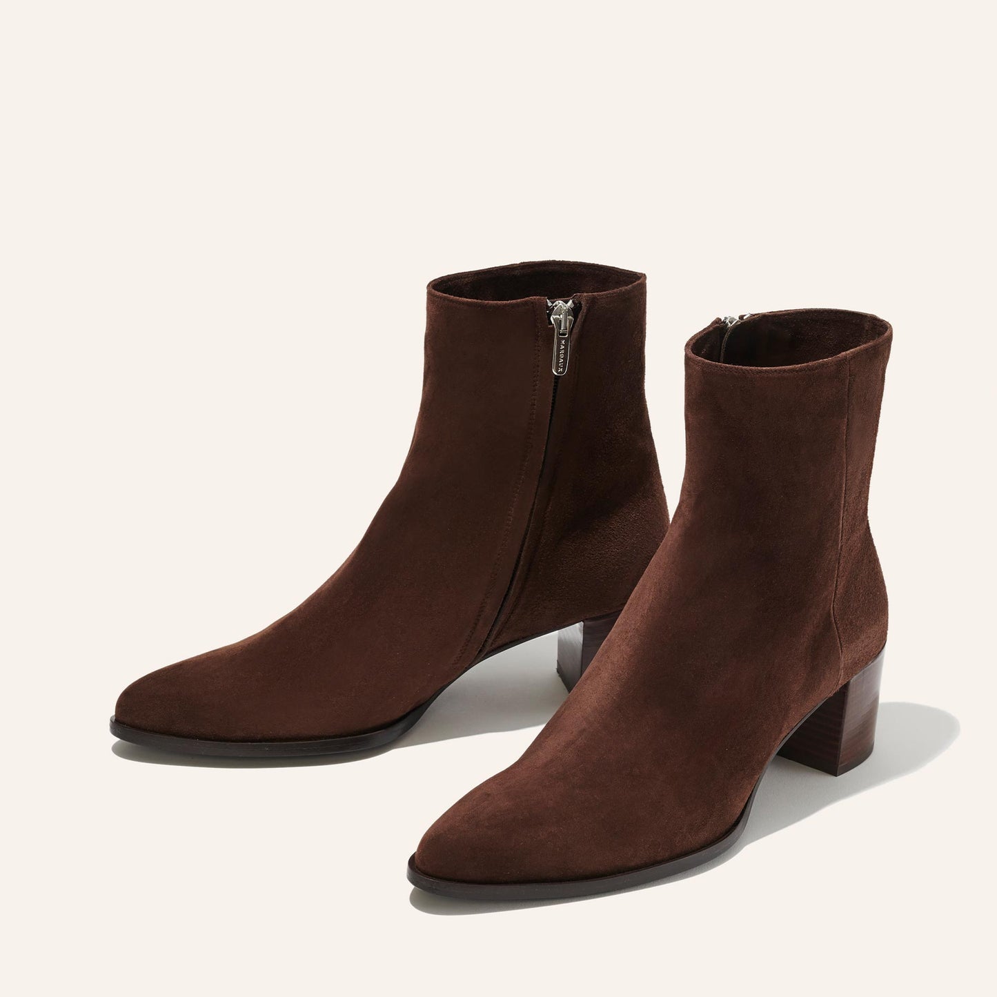 The Downtown Boot in Chocolate Suede, a chic ankle-height design complete with a Western-inspired welt and a comfortable 2.5-inch stacked heel.