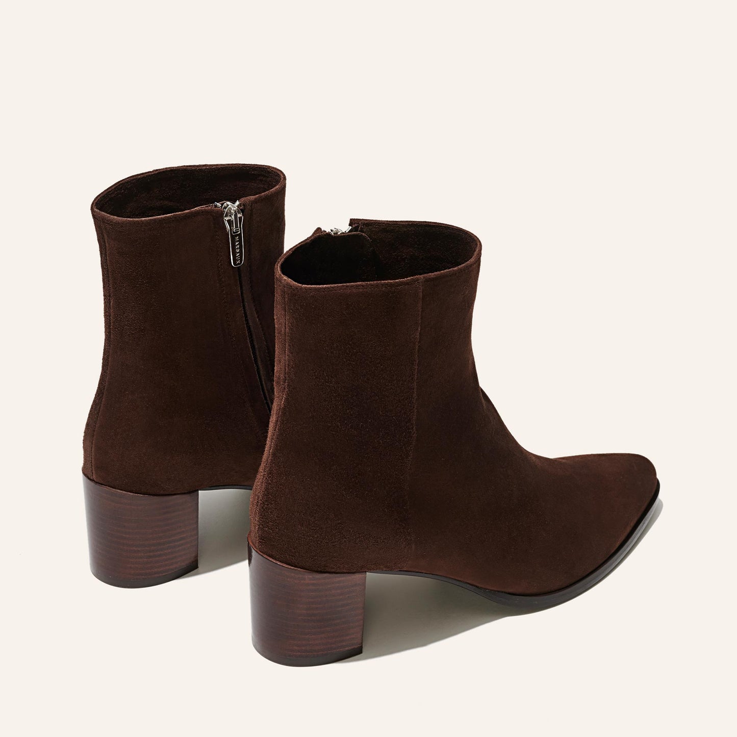 The Downtown Boot in Chocolate Suede, a chic ankle-height design complete with a Western-inspired welt and a comfortable 2.5-inch stacked heel.