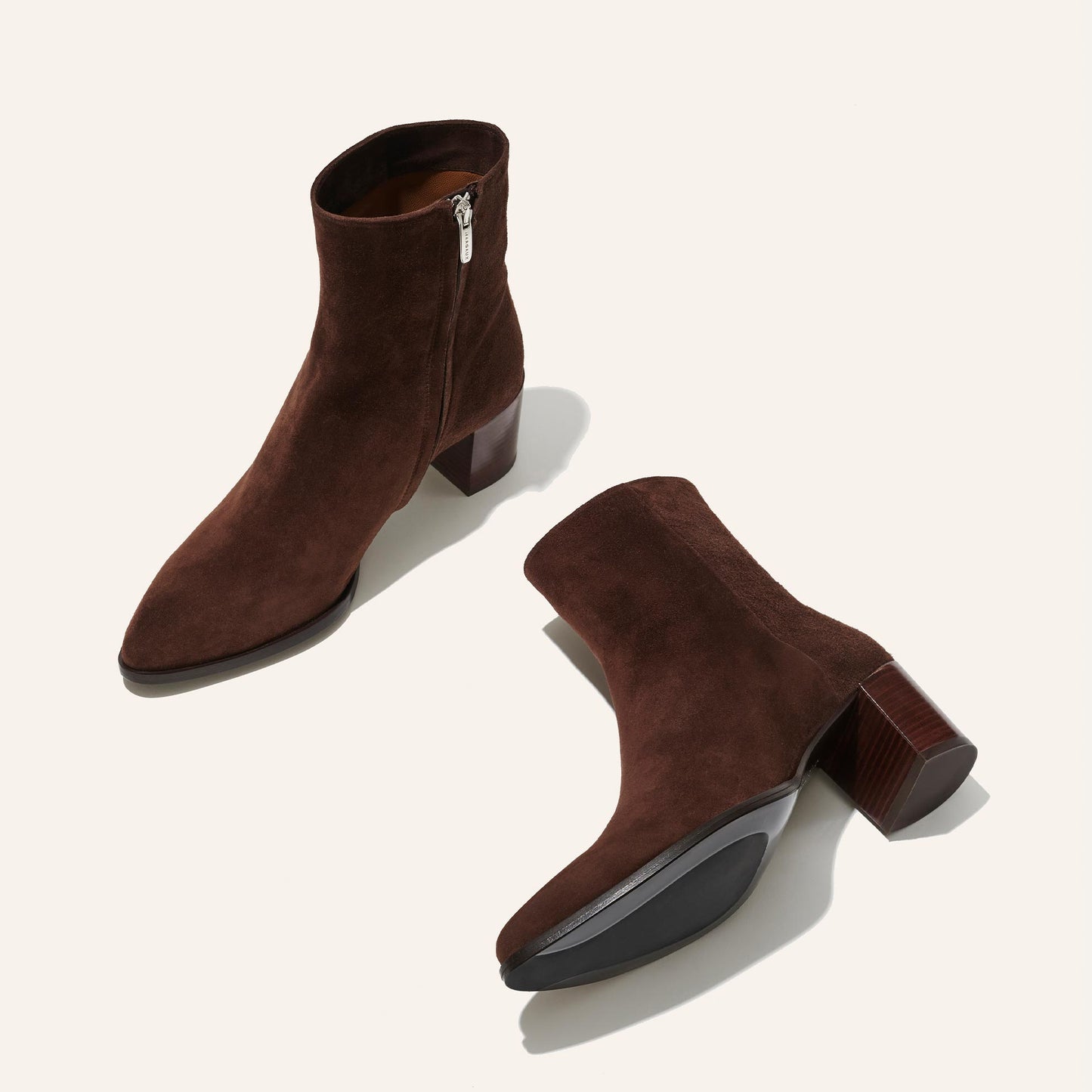 The Downtown Boot in Chocolate Suede, a chic ankle-height design complete with a Western-inspired welt and a comfortable 2.5-inch stacked heel.
