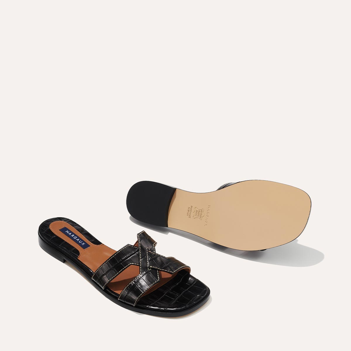 The MX Sandal in Black, a slip-on sandal featuring croc-embossed Italian calf leather with structured straps and a subtly square toe.