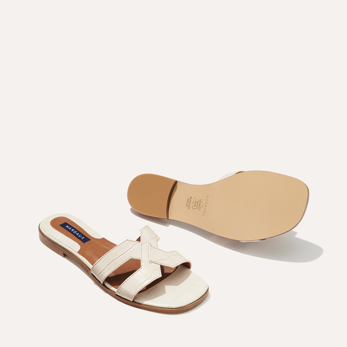 The MX Sandal in Cream, a slip-on sandal featuring croc-embossed Italian calf leather with structured straps and a subtly square toe.