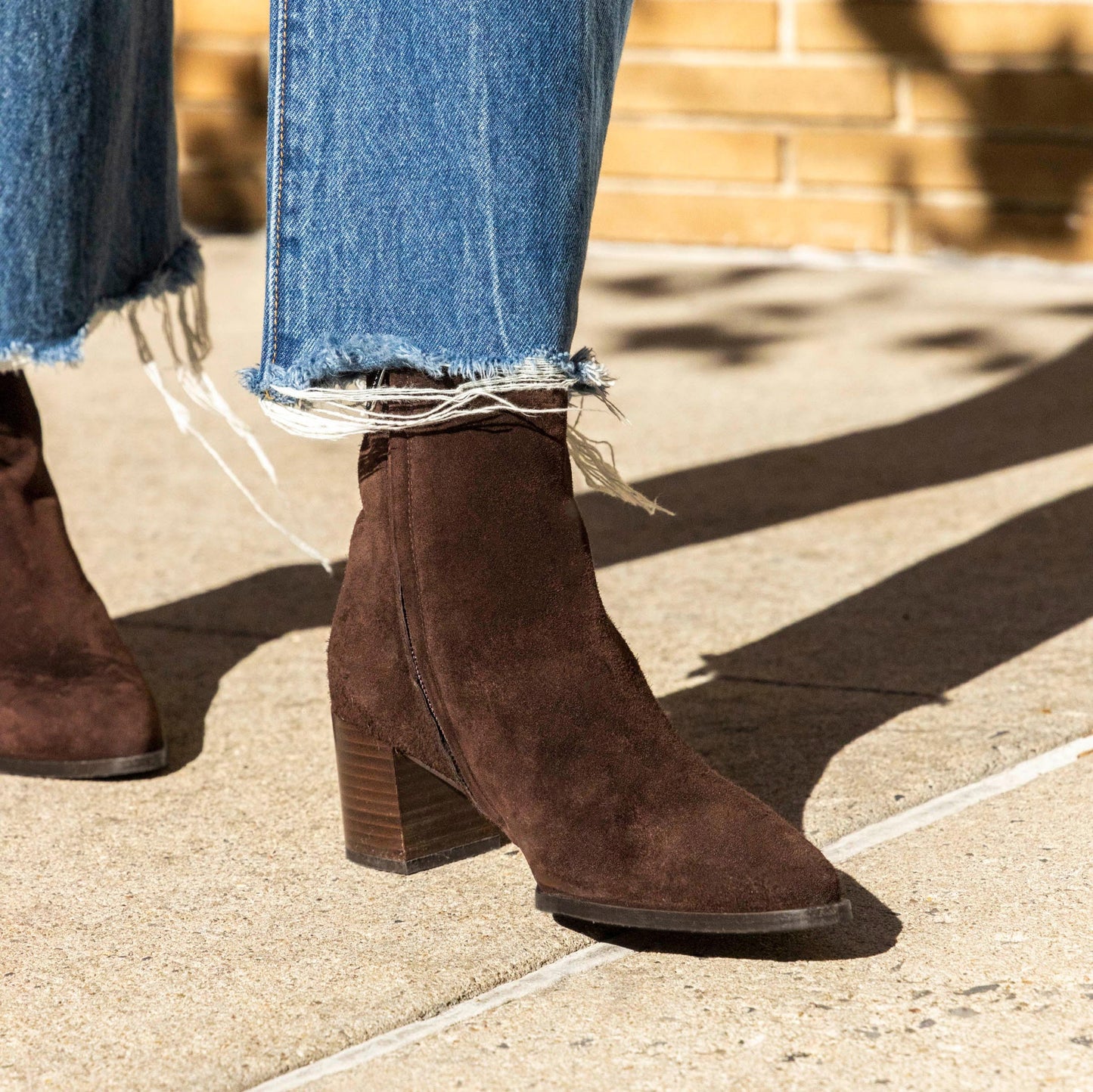 The Downtown Boot in Chocolate Suede, a chic ankle-height design complete with a Western-inspired welt and a comfortable 2.5-inch stacked heel.