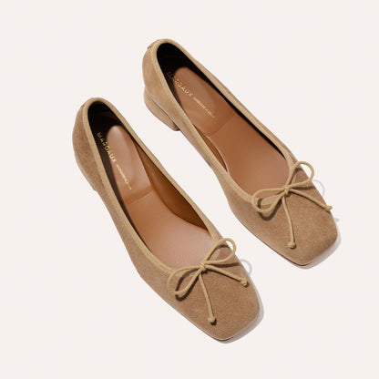 The Ada - Biscotti Suede by margaux-development: classic tan suede ballet pumps with low heels, square toes, and matching bows, shown on a light background.