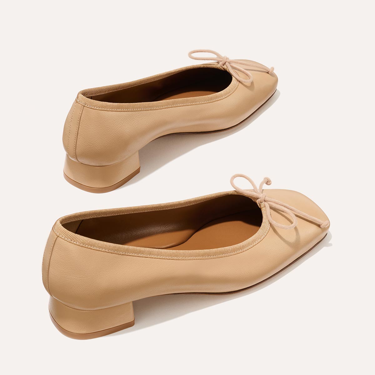 The Ada in Dune Nappa, a comfortable ballet flat with a square toe, adjustable cord bow detail, and comfortable 1-inch block heel.