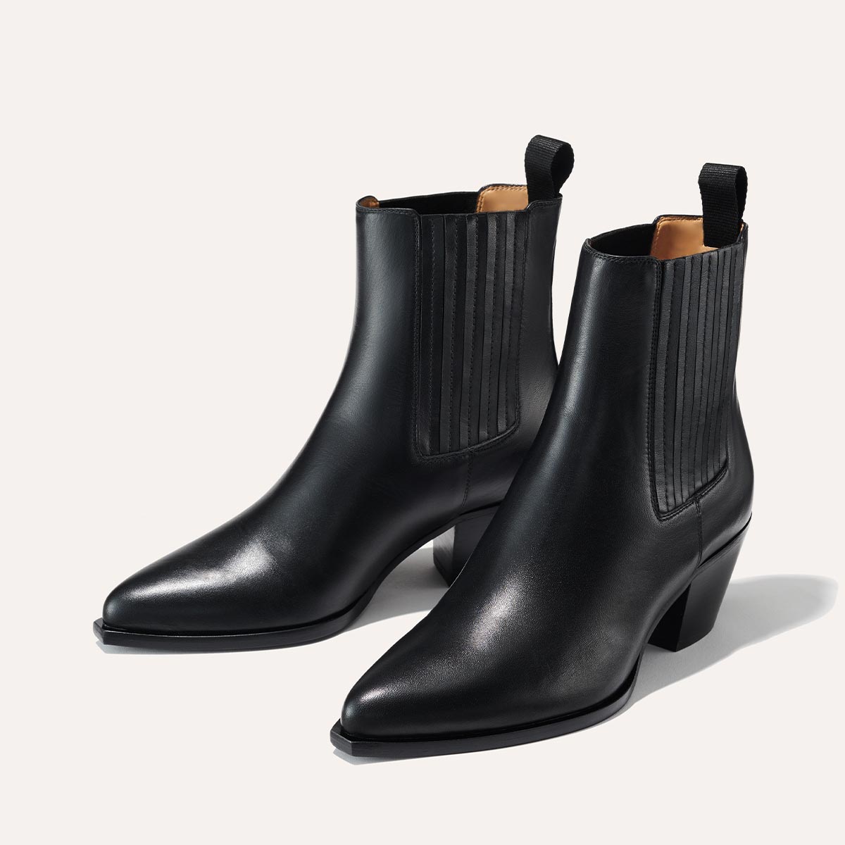 The Agnes Boot in Black Calf, featuring a sleek design inspired by classic Western styles, crafted from high-quality leather with a squared-off toe and angular heel.