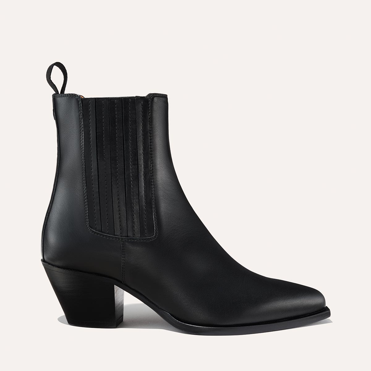 The Agnes Boot in Black Calf, featuring a sleek design inspired by classic Western styles, crafted from high-quality leather with a squared-off toe and angular heel.