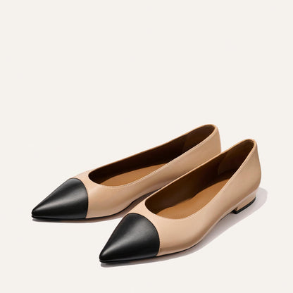 The Alba - Dune and Black Nappa by Margaux: beige ballet flats with pointed toes and black caps, featuring a cushioned insole, shown on a light background.