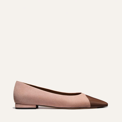 Two-tone pink and brown flat shoe on a light beige background