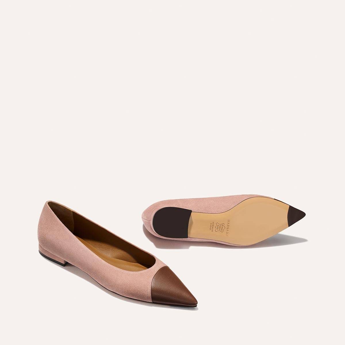 Pink and brown pointed-toe flats on a white background