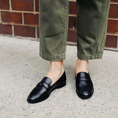 The Andie Loafer in Black Nappa, featuring a sleek structured design made from smooth Italian nappa leather with a minimalistic padded keeper detail.