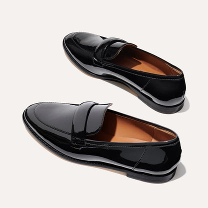 The Andie Loafer in shiny Black Patent, featuring a sleek structured design made from smooth Italian nappa leather with a minimalistic padded keeper detail.