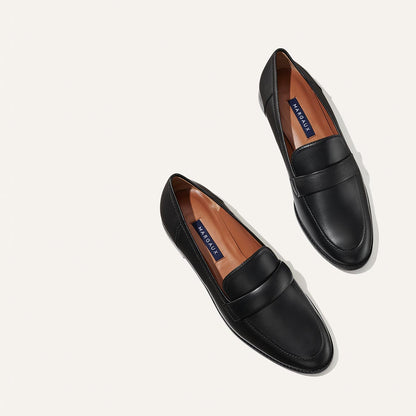 The Andie Loafer in Black Nappa, featuring a sleek structured design made from smooth Italian nappa leather with a minimalistic padded keeper detail.