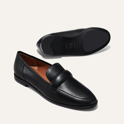The Andie Loafer in Black Nappa, featuring a sleek structured design made from smooth Italian nappa leather with a minimalistic padded keeper detail.