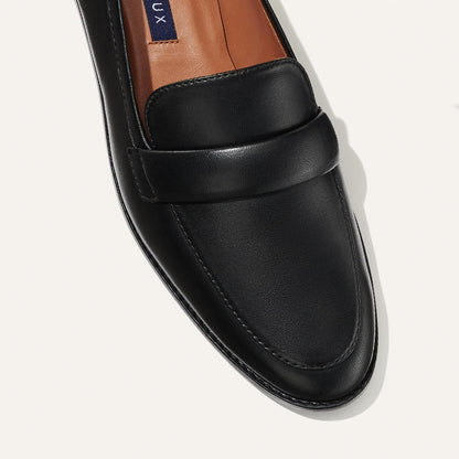 The Andie Loafer in Black Nappa, featuring a sleek structured design made from smooth Italian nappa leather with a minimalistic padded keeper detail.