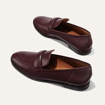 The Andie Loafer in Burgundy Nappa, featuring a sleek structured design made from smooth Italian nappa leather with a minimalistic padded keeper detail.
