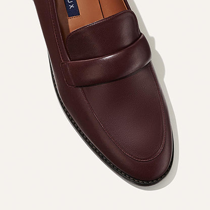 The Andie Loafer in Burgundy Nappa, featuring a sleek structured design made from smooth Italian nappa leather with a minimalistic padded keeper detail.