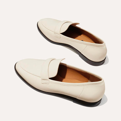 The Andie Loafer in Ecru Nappa, featuring a sleek structured design made from smooth Italian nappa leather with a minimalistic padded keeper detail.